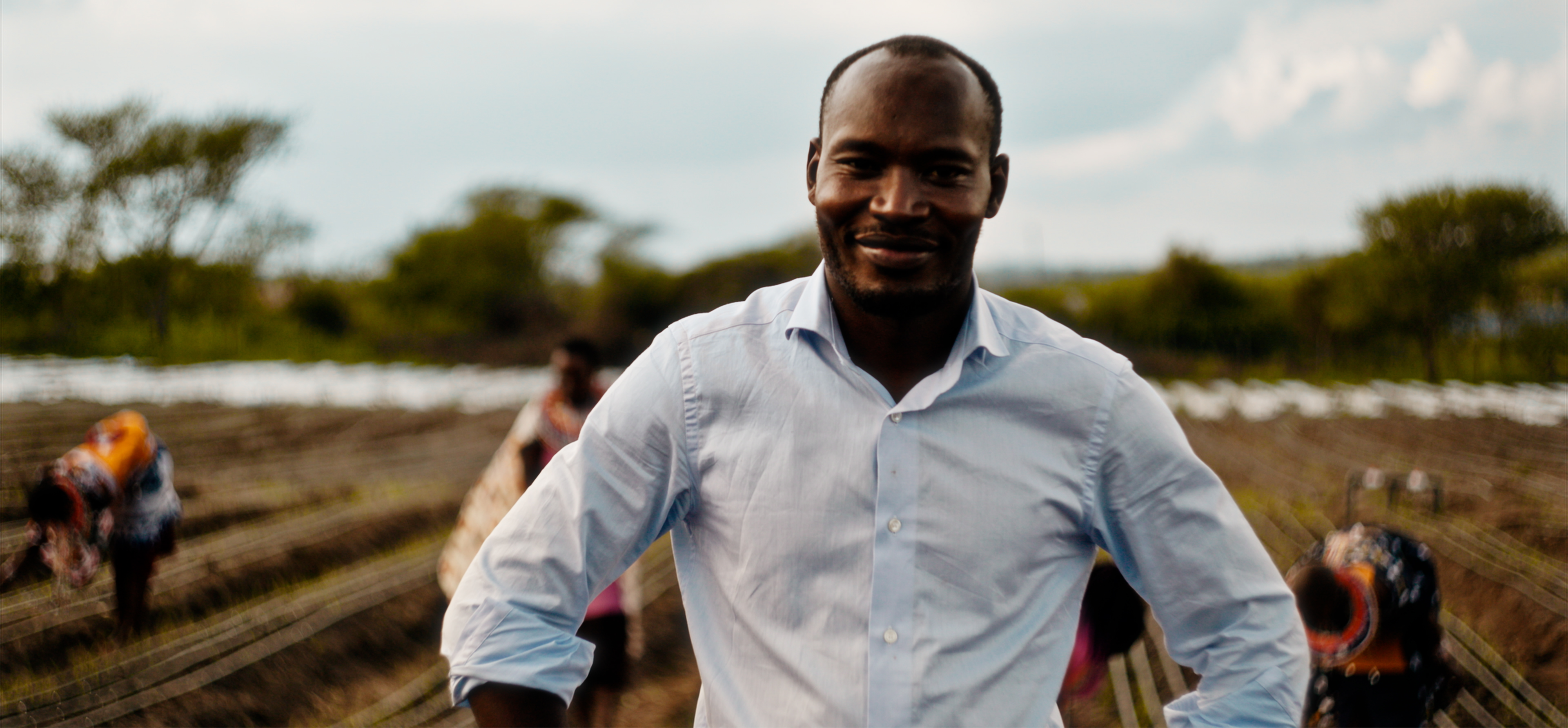 Eric Bosire standing on a field on a cloud day