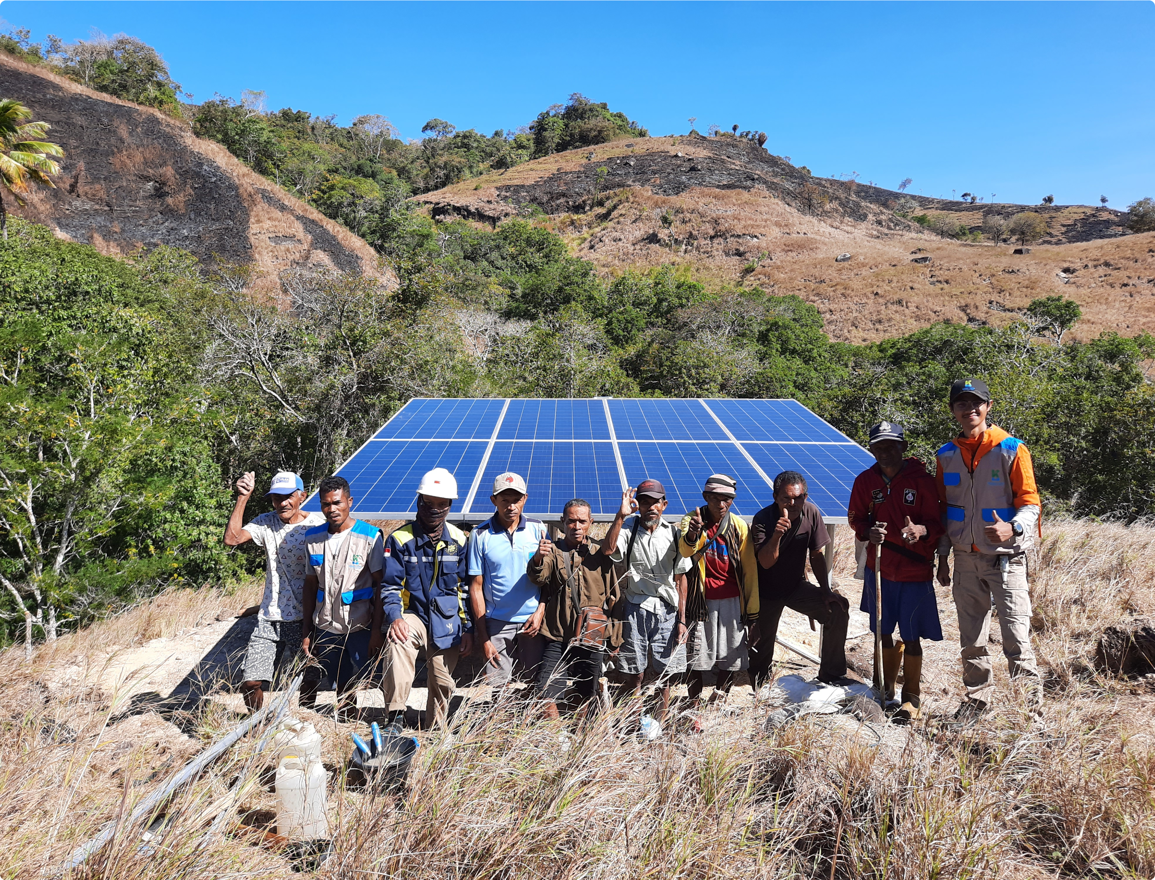 Group in front of newly built solar panel