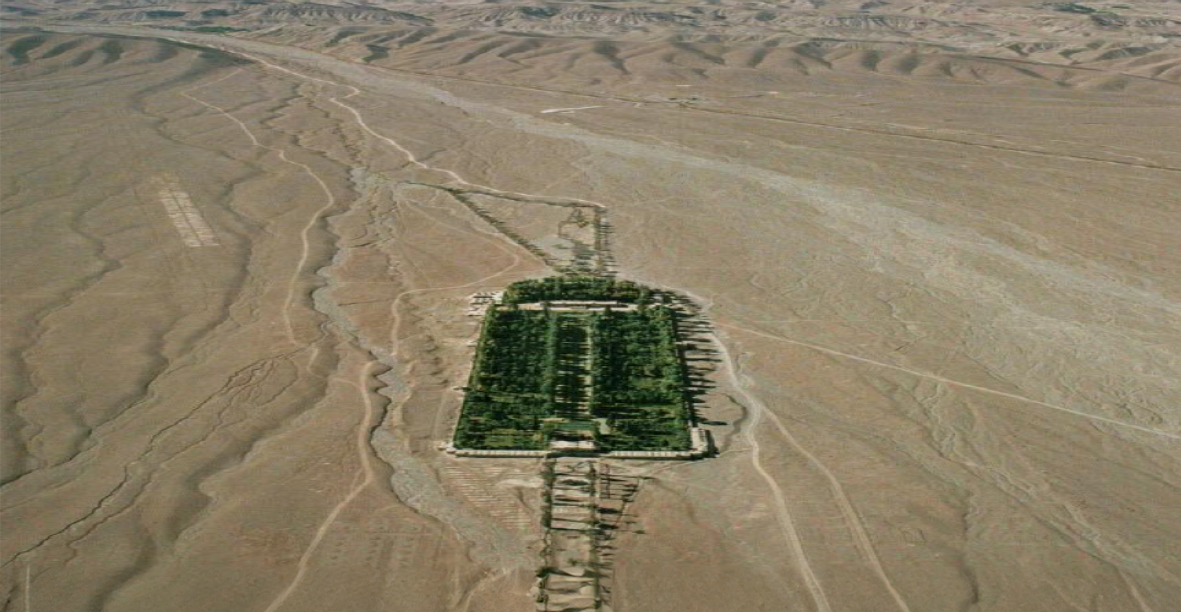 Aerial shot of green garden in front of mount Joupar