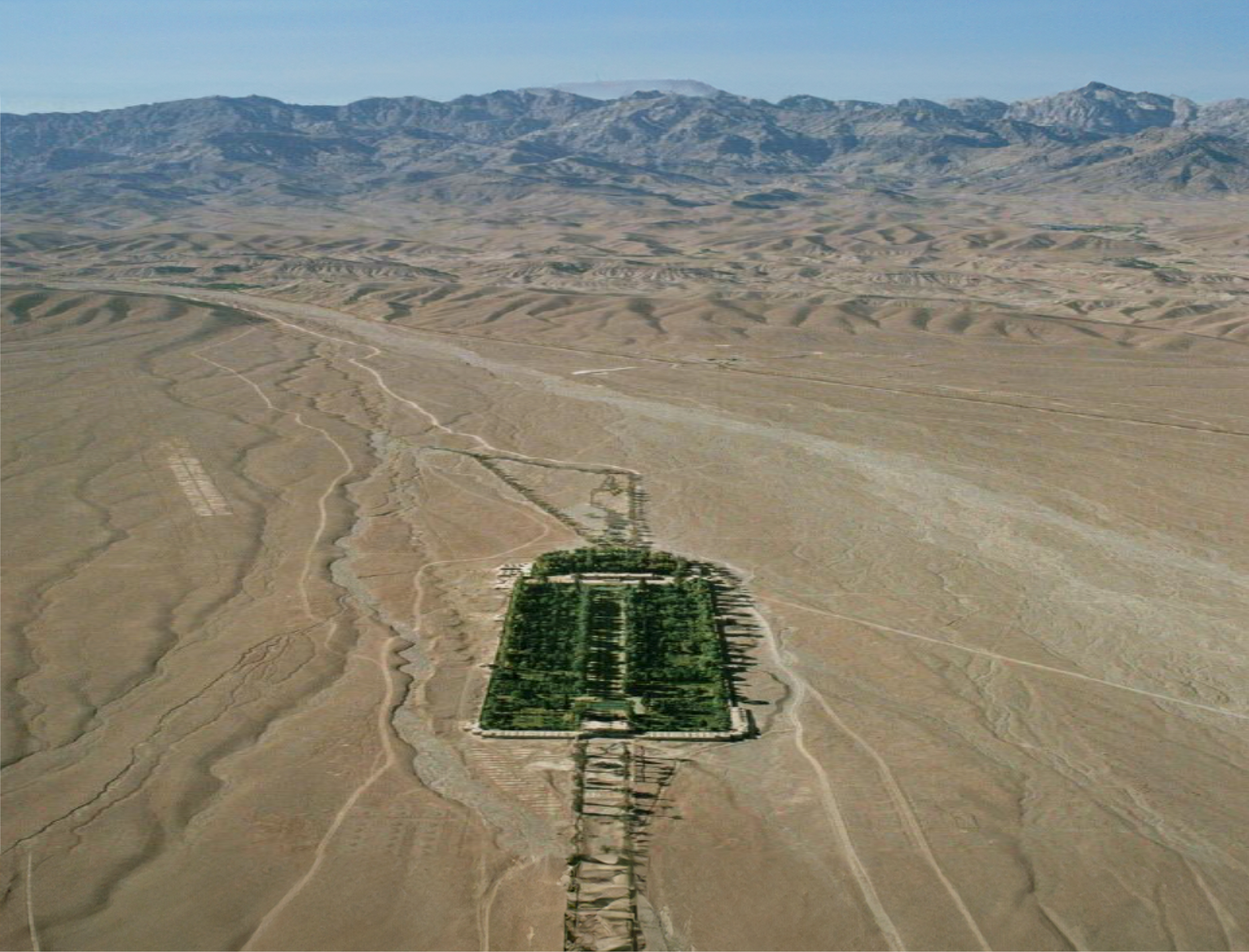 Aerial shot of green garden in front of mount Joupar