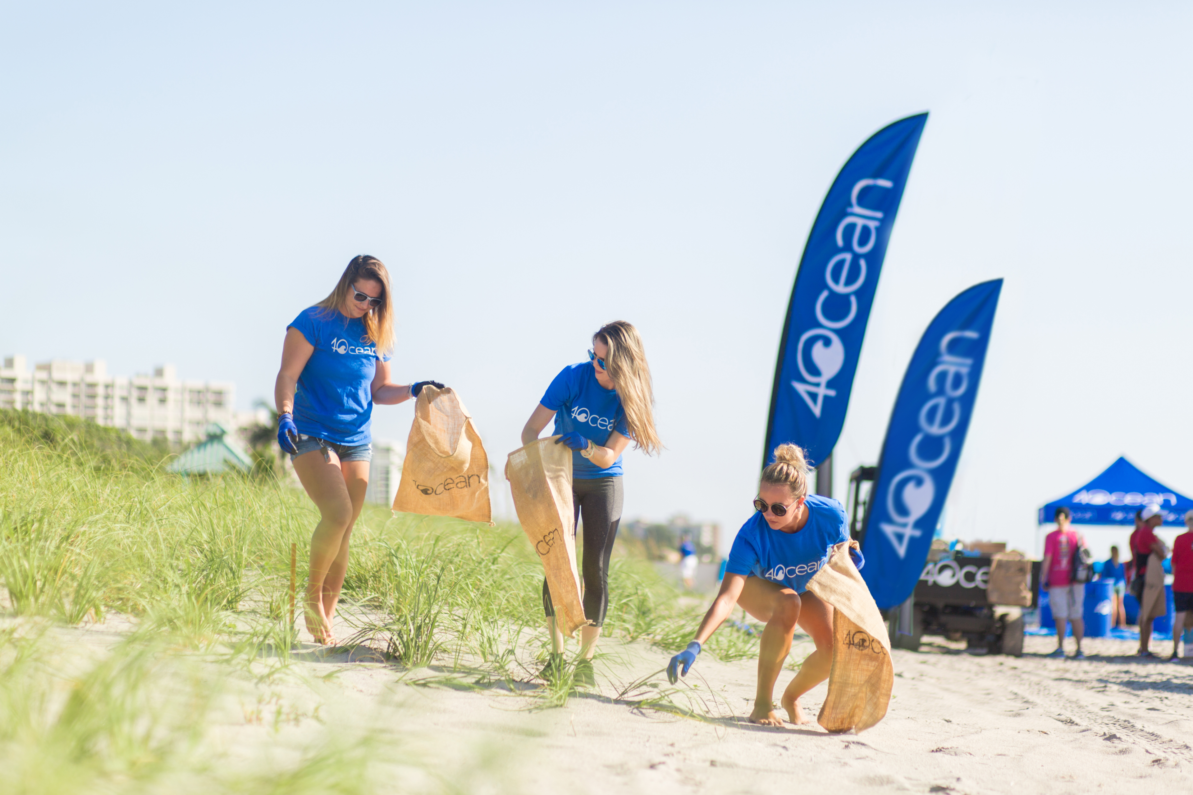 4ocean workers picking up trash at the beach